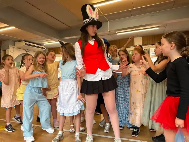 Madison leading a costumed rehearsal